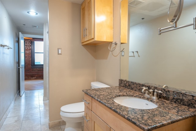 bathroom with tile patterned flooring, vanity, and toilet