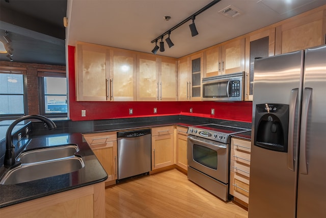 kitchen featuring track lighting, light hardwood / wood-style flooring, sink, light brown cabinets, and appliances with stainless steel finishes