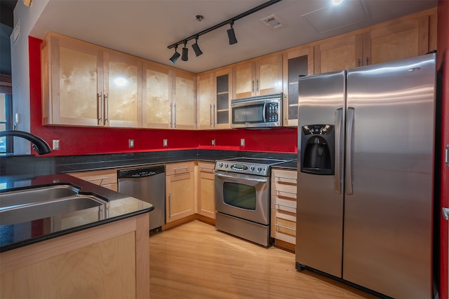 kitchen with light hardwood / wood-style floors, sink, appliances with stainless steel finishes, light brown cabinetry, and rail lighting