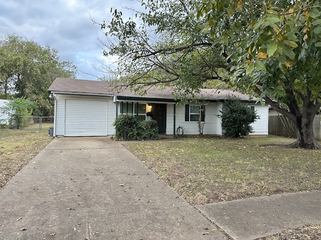 ranch-style house featuring a garage and a front yard