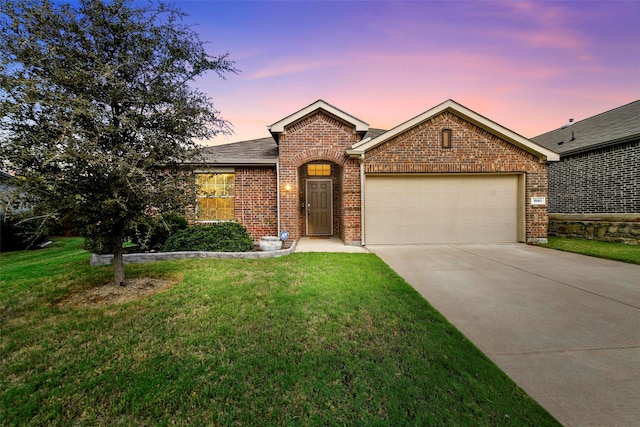 view of front of home with a lawn and a garage