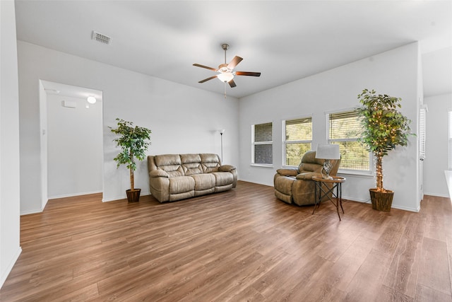 living room with ceiling fan and wood-type flooring