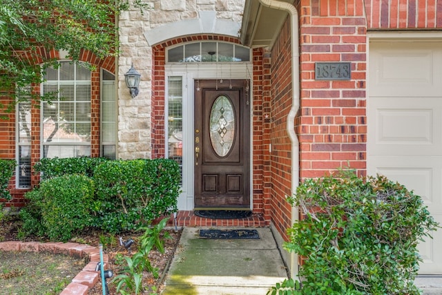 doorway to property featuring a garage