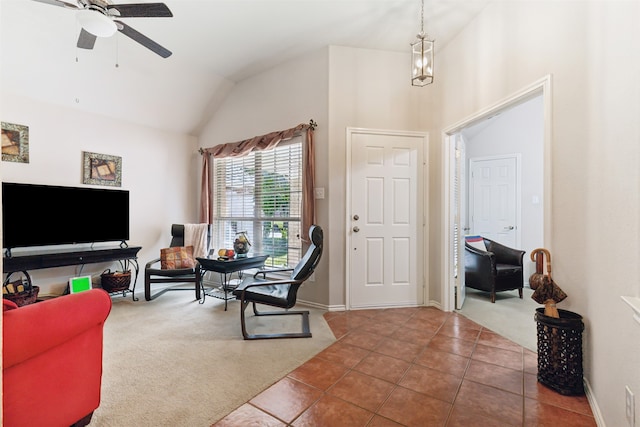 interior space featuring ceiling fan, tile patterned floors, and lofted ceiling