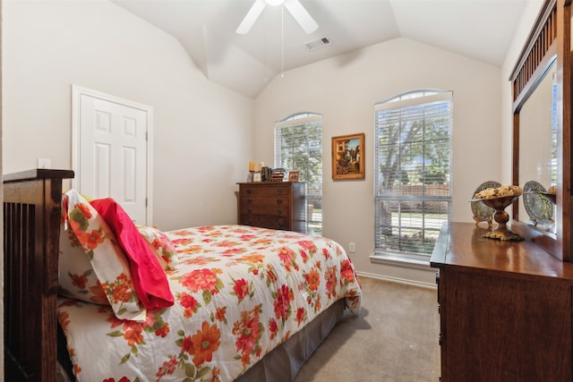 carpeted bedroom with vaulted ceiling and ceiling fan