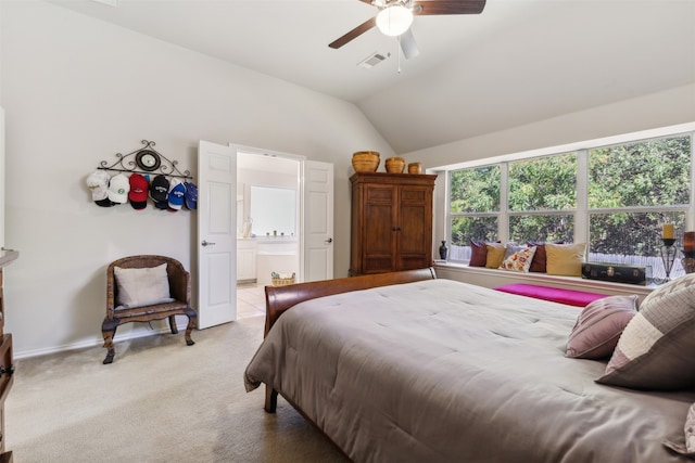 carpeted bedroom featuring connected bathroom, vaulted ceiling, and ceiling fan