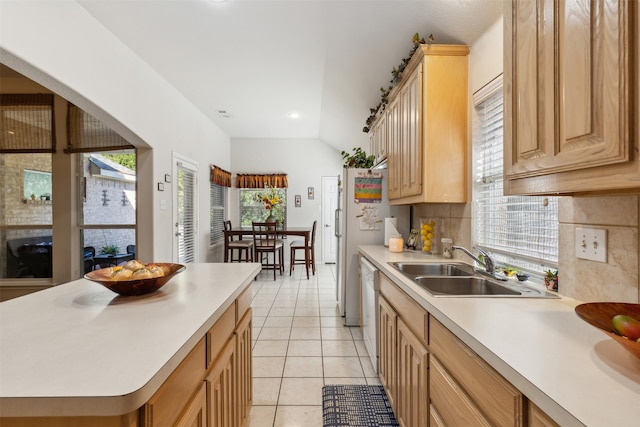 kitchen featuring light brown cabinets, decorative backsplash, a healthy amount of sunlight, and light tile patterned floors