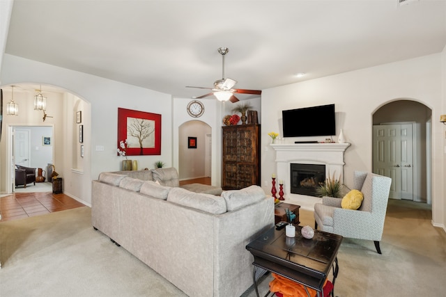 living room featuring light carpet and ceiling fan