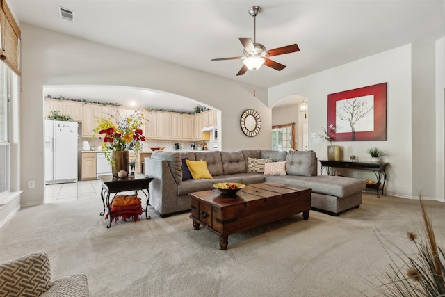 living room featuring light carpet and ceiling fan