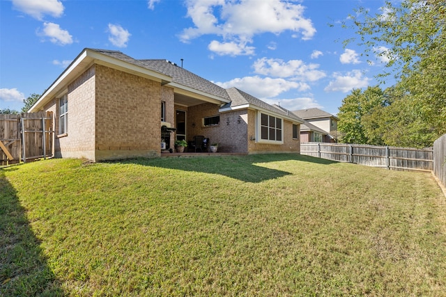 back of house featuring a yard