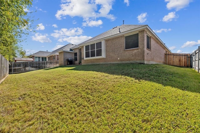 rear view of house with a yard