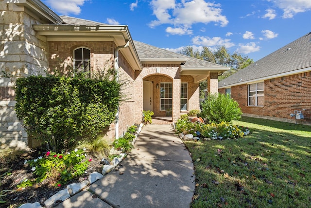 doorway to property featuring a yard