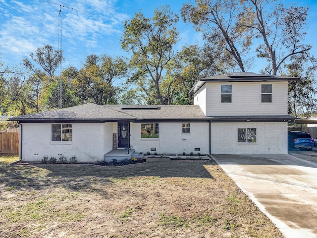 view of front of home with solar panels and a carport