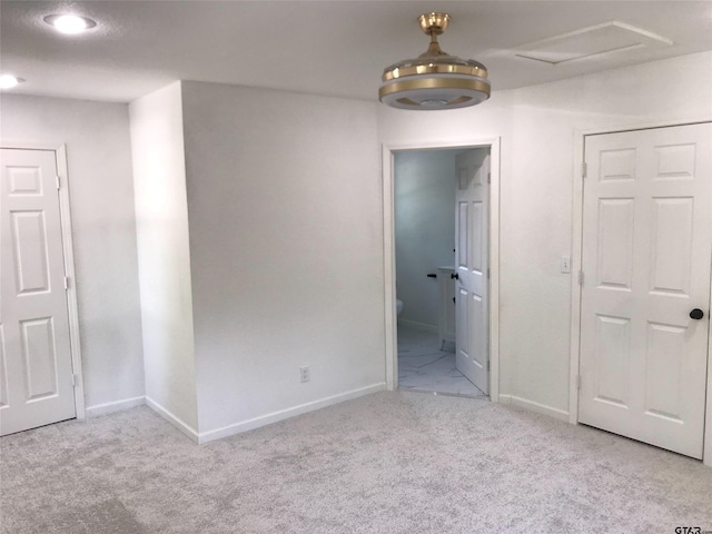 unfurnished bedroom featuring light carpet