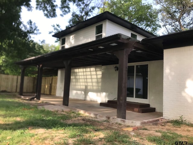 view of side of home with a pergola and a patio area