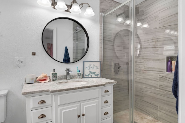 bathroom featuring walk in shower and vanity