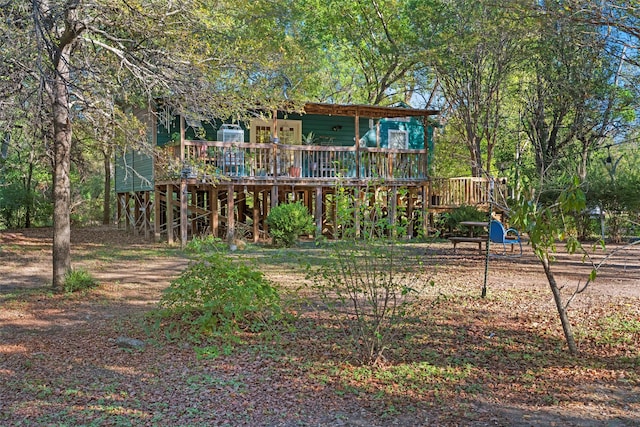 rear view of property featuring a deck