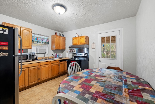 kitchen with a textured ceiling, sink, and appliances with stainless steel finishes