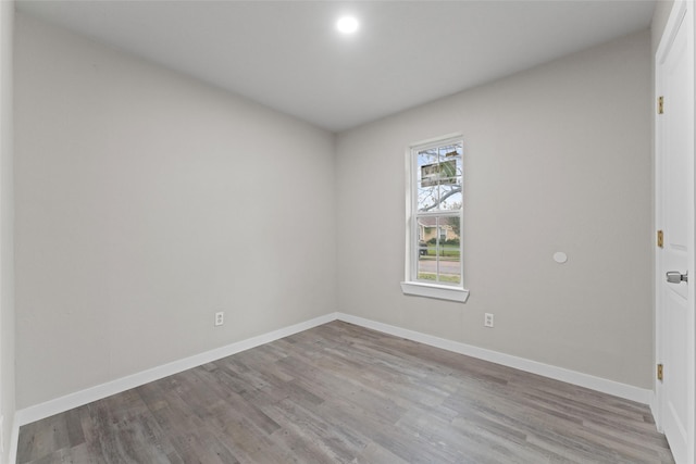 unfurnished room with light wood-type flooring