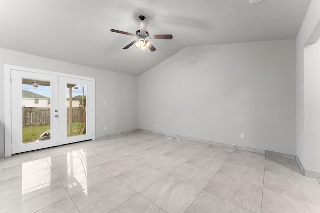 empty room featuring vaulted ceiling, ceiling fan, and french doors