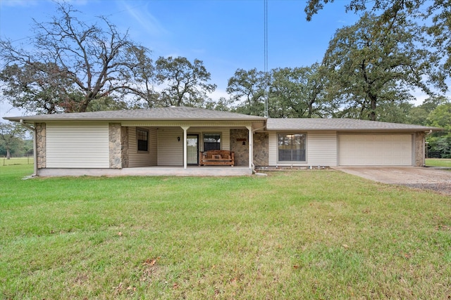 ranch-style house with a garage, covered porch, and a front lawn