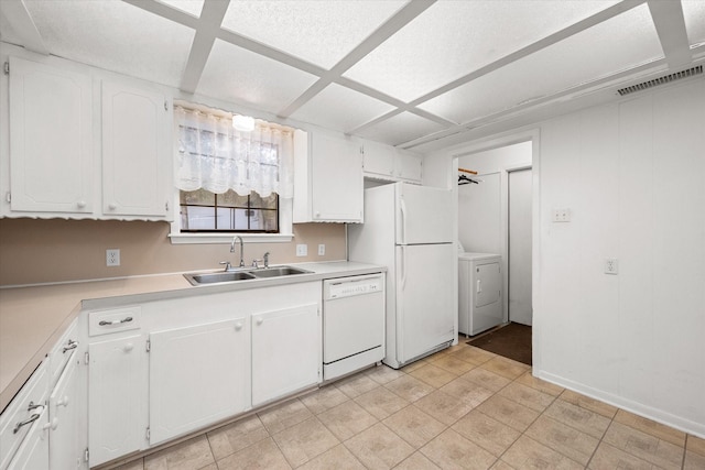 kitchen featuring white appliances, washer / clothes dryer, sink, and white cabinets