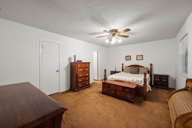 carpeted bedroom with ceiling fan and a textured ceiling