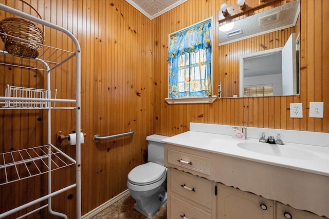 bathroom featuring vanity, crown molding, toilet, and wood walls