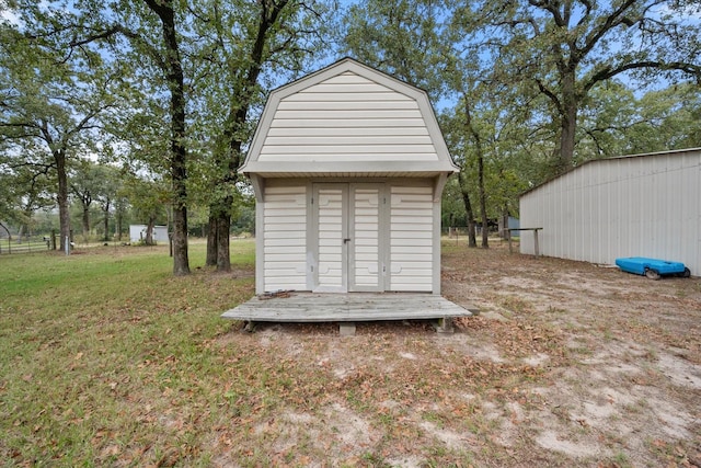 view of community featuring a lawn and a storage shed