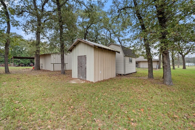 view of outbuilding featuring a yard