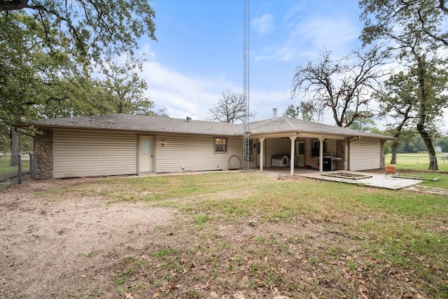 rear view of house featuring a patio and a lawn