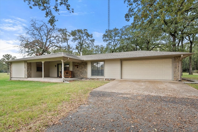 ranch-style home featuring a garage, a front yard, and covered porch