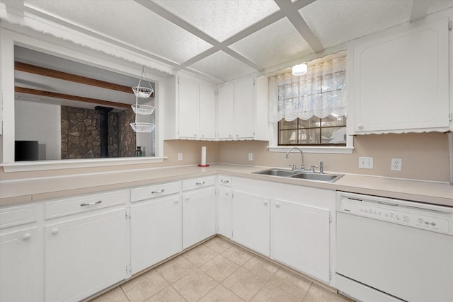 kitchen featuring sink, white cabinetry, light tile patterned floors, white dishwasher, and beam ceiling