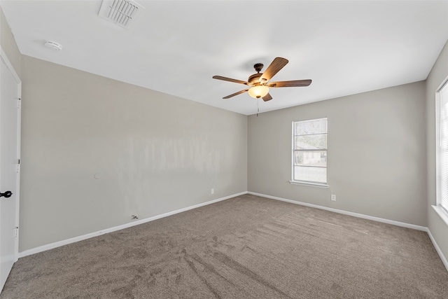 spare room featuring carpet flooring and ceiling fan