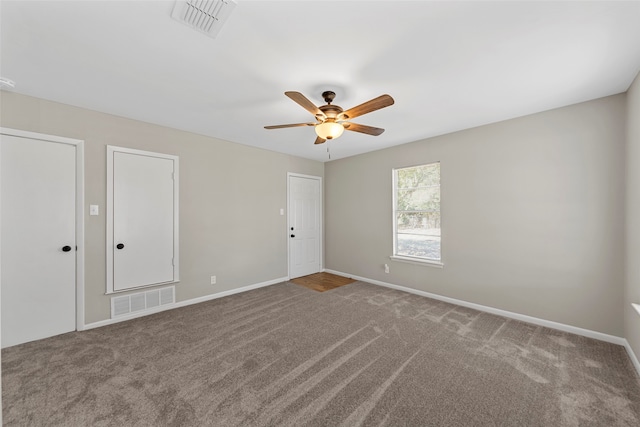 carpeted spare room featuring ceiling fan