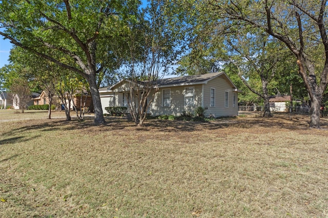 ranch-style home featuring a front yard