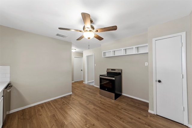 kitchen featuring hardwood / wood-style floors, stainless steel electric range, and ceiling fan