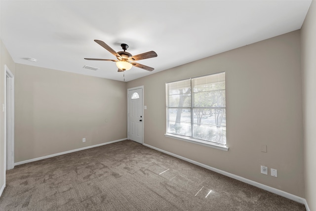 spare room featuring ceiling fan and light colored carpet