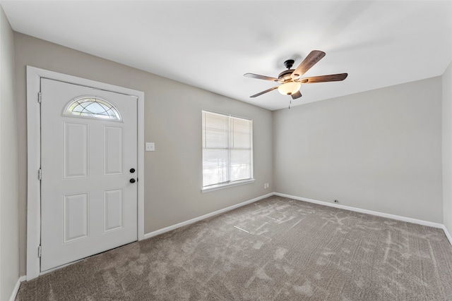 carpeted foyer featuring plenty of natural light and ceiling fan