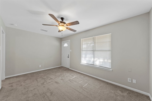 carpeted empty room featuring ceiling fan