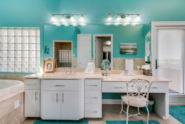 bathroom featuring vanity, tile patterned floors, and tiled tub