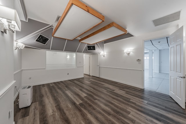 basement with dark hardwood / wood-style floors