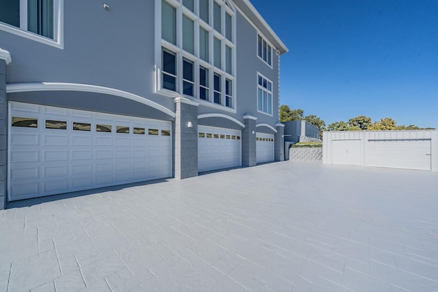 view of front of property featuring a garage, driveway, and stucco siding
