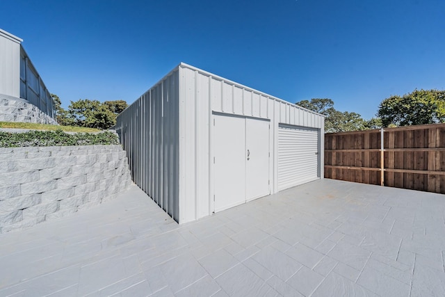 view of outbuilding with an outbuilding and fence