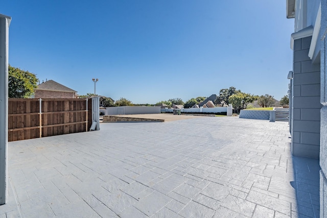 view of patio featuring fence