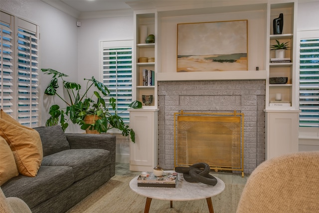 living area featuring a fireplace, built in shelves, and ornamental molding