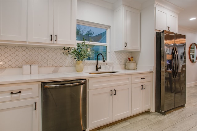 kitchen with white cabinetry, dishwasher, sink, refrigerator with ice dispenser, and ornamental molding