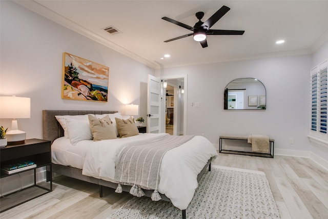 bedroom featuring ceiling fan, light hardwood / wood-style flooring, and ornamental molding