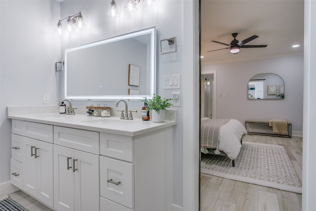 bathroom with hardwood / wood-style floors, vanity, and ceiling fan