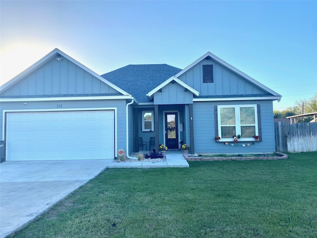 view of front of property featuring a garage and a front lawn